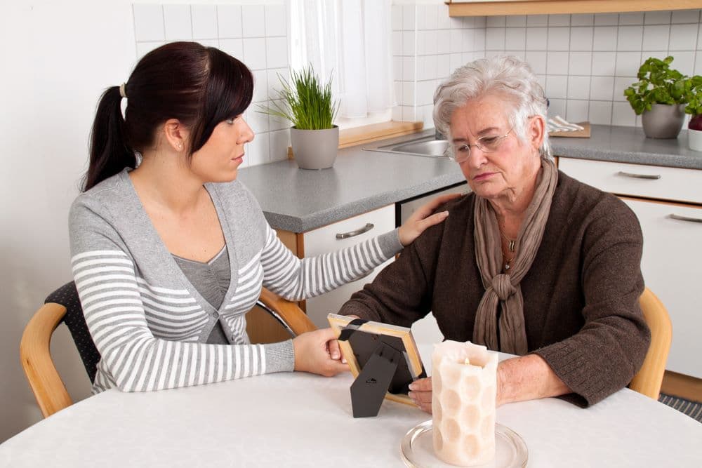 Young widow receiving comfort and grief counseling after the loss of her spouse.