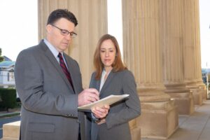 Attorneys Matthew Bligh and Erin Hargis review case details outside courthouse