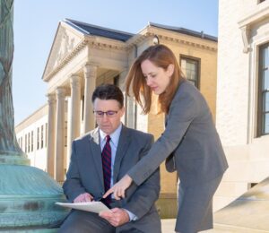 Attorneys Matthew Bligh and Erin Hargis reviewing case outside courthouse