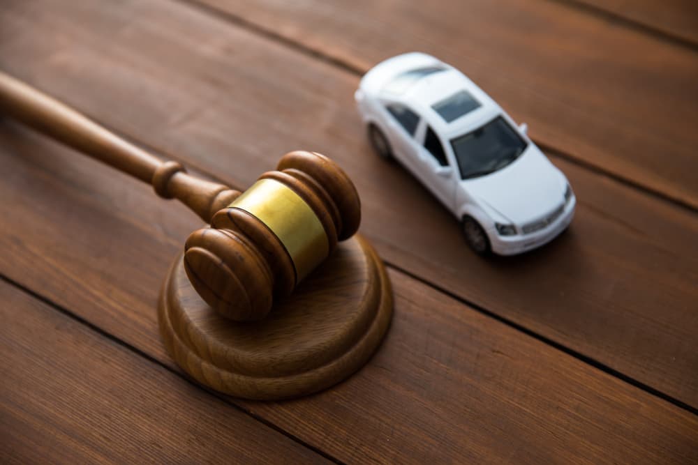 Model car with a judge figure on a table.