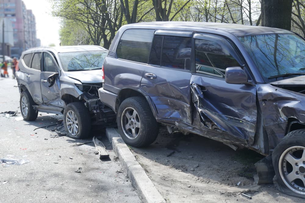 Close-up of cars crashed into a tree after a road accident in the city