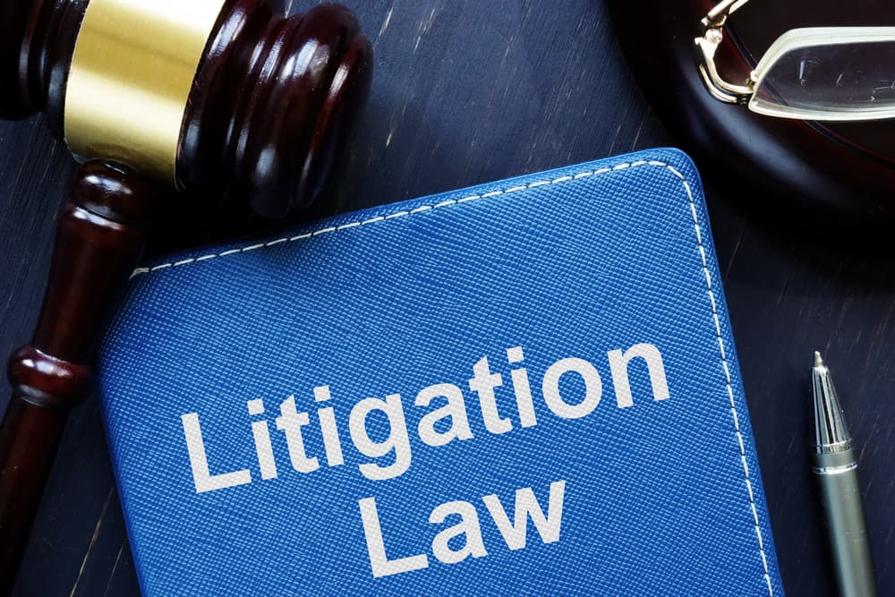 The photo displays the text "Litigation Law" as a prominent feature.