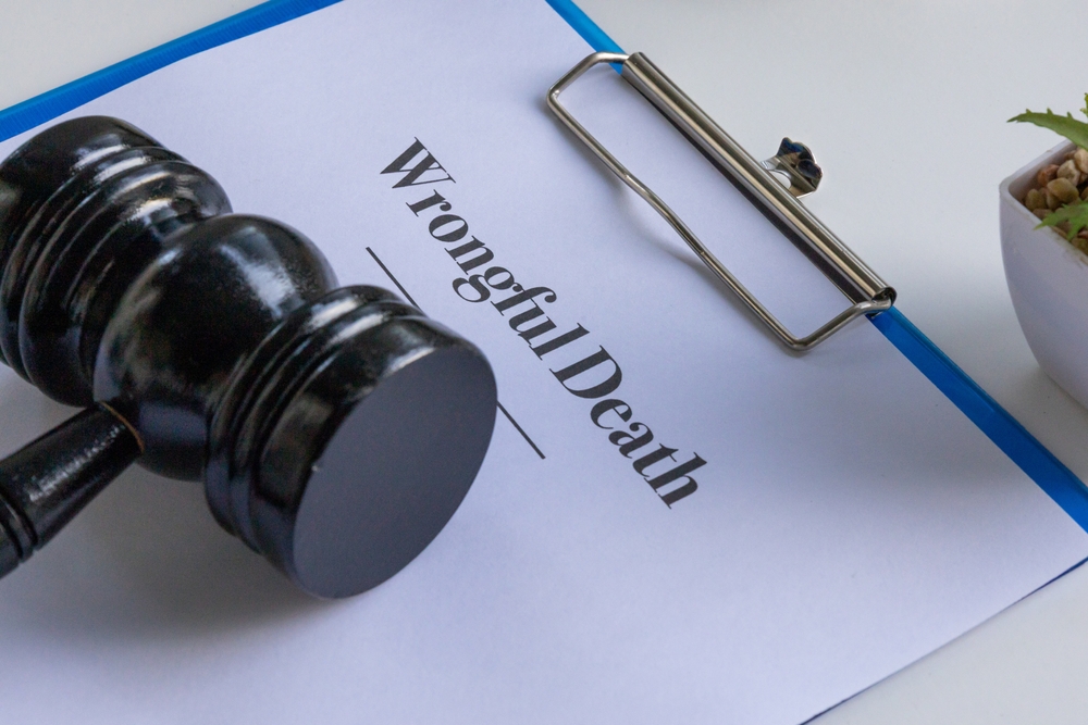 Close-up of a gavel resting on a clipboard with the words Wrongful Death, symbolizing legal action and justice for grieving families.